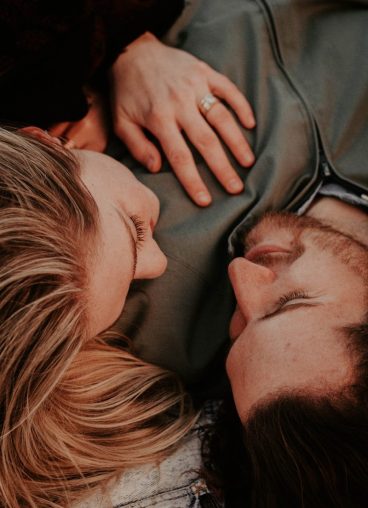 a woman stares into a man's eyes lovingly